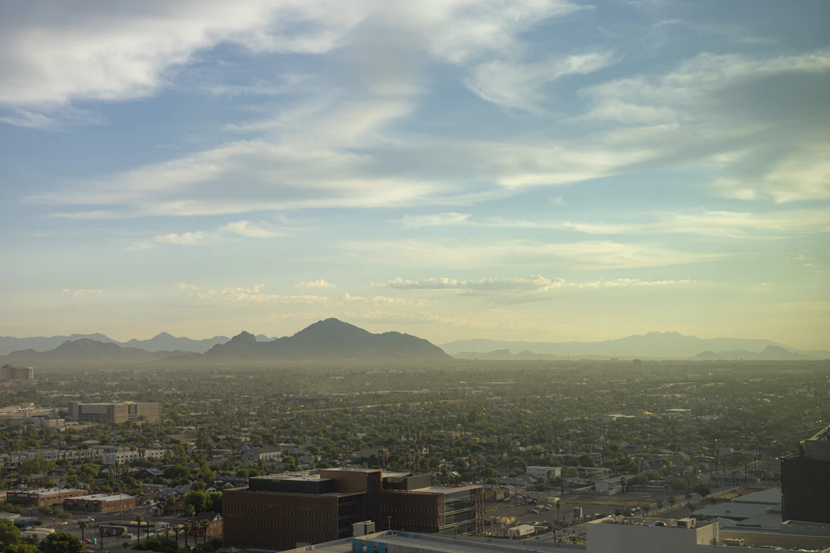 Phoenix buildings at sunrise with Camelback Mountain in the distance